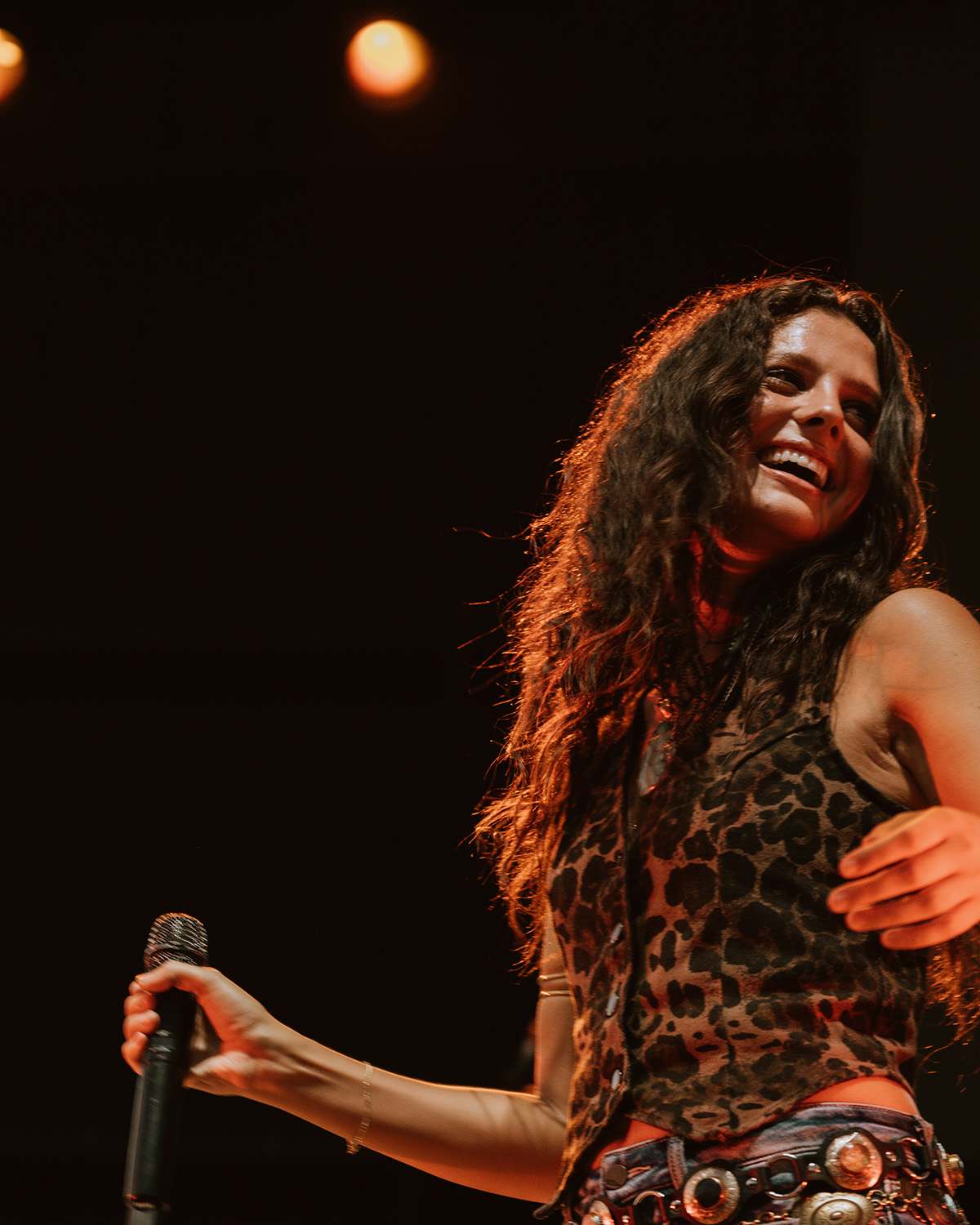 Lanie Gardner smiles with a microphone in hand